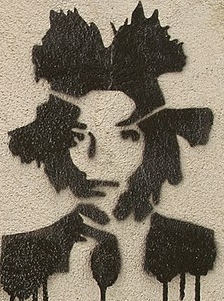A Creative Commons photograph associated with Basquiat graffiti, showing dripping marks and layered street-art texture