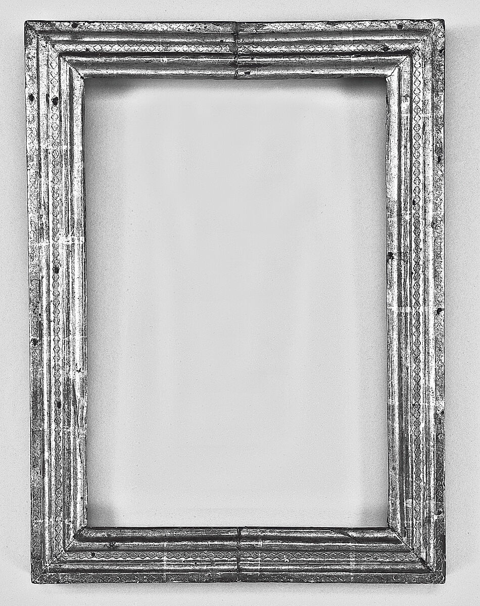 A fifteenth-century Sienese cassetta frame with gilded punched decoration around a Madonna and Child painting